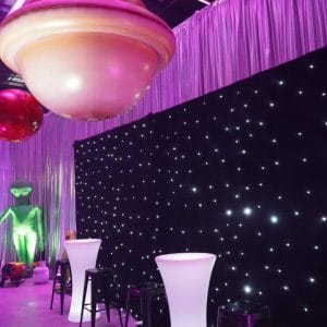 star cloth, illuminated furniture and inflatable planet at space themed party