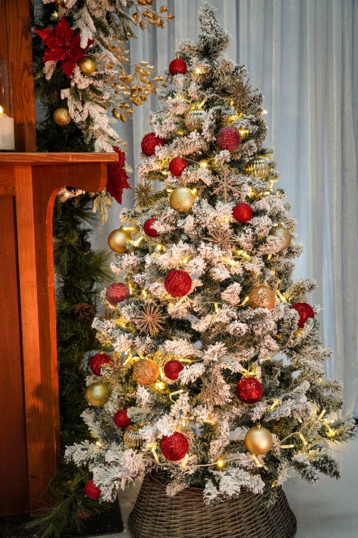 white frosted christmas tree with red and gold ornaments