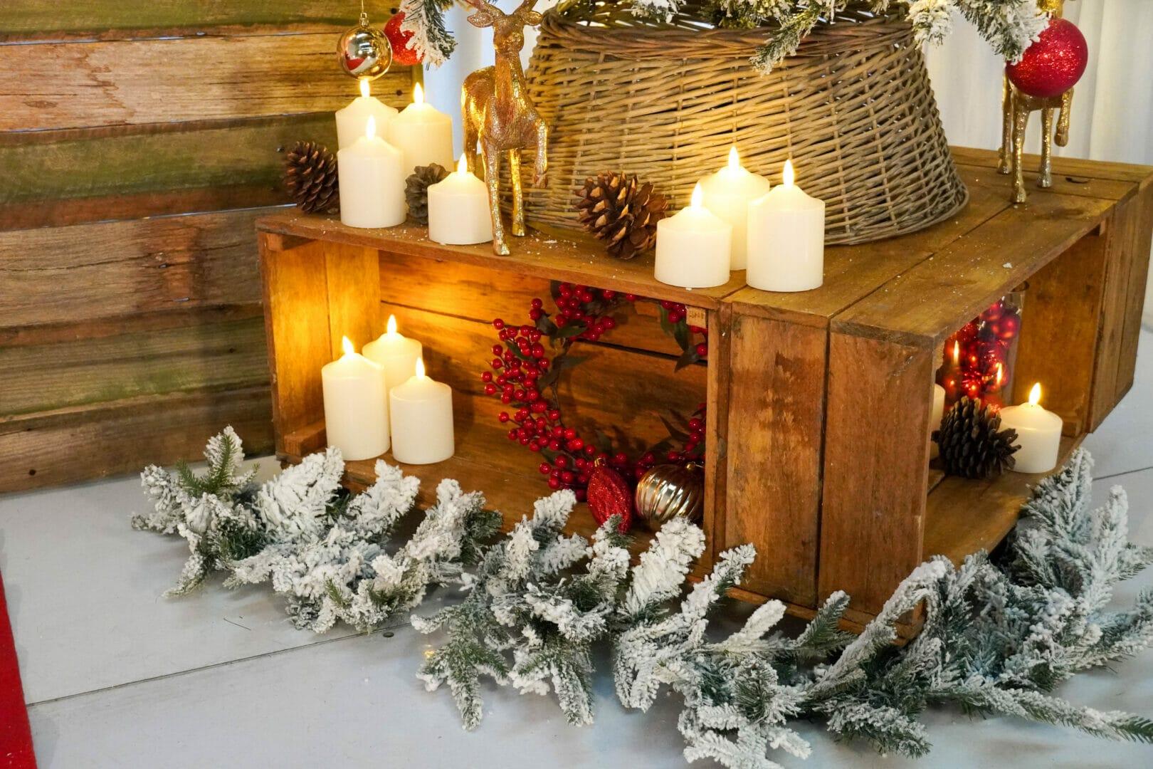 christmas party theme with frosted pine garland, candles, pinecones and ornaments