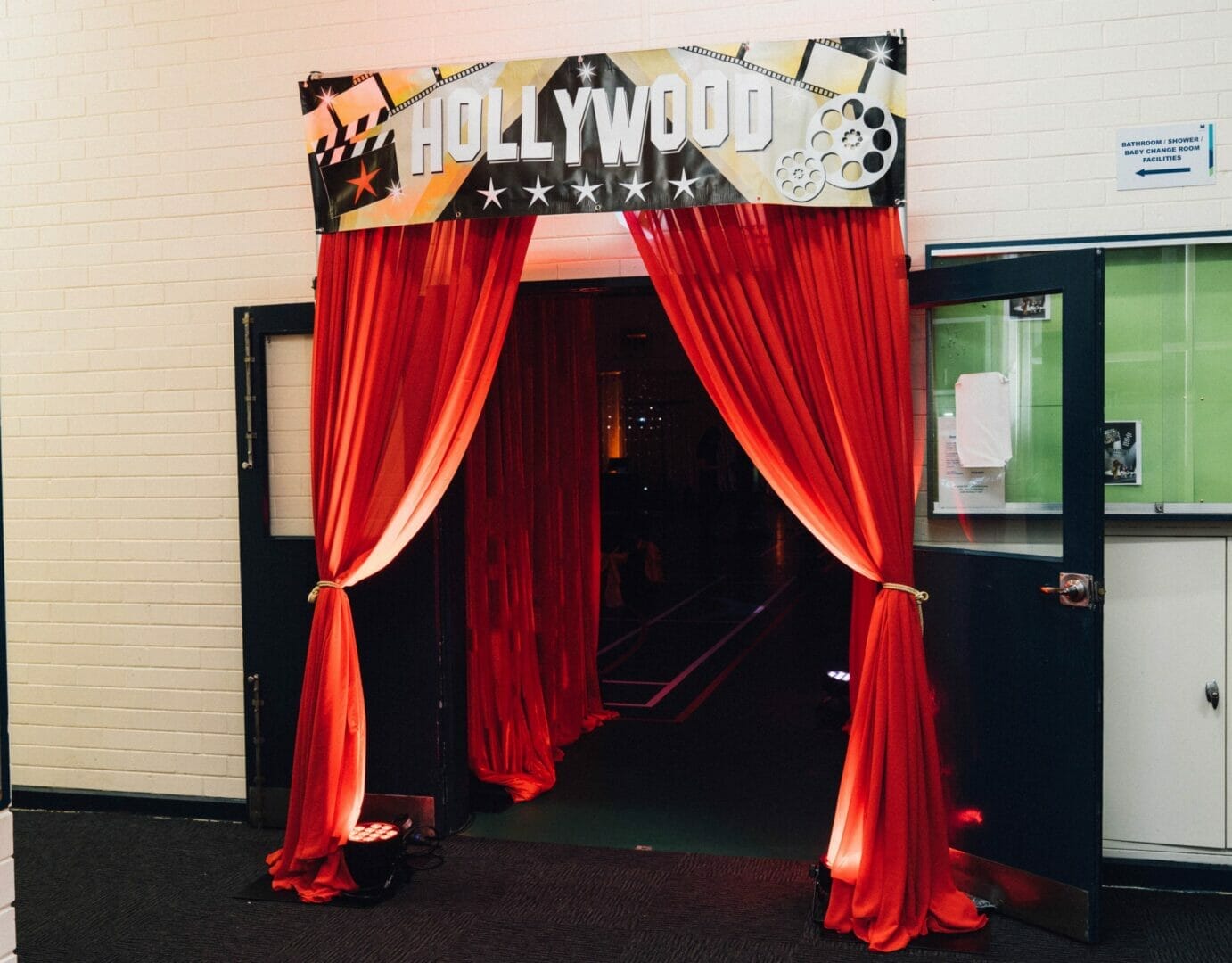 hollywood themed entrance banner with red chiffon drape