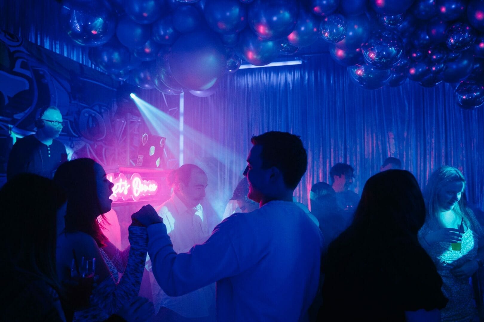 people dancing on dance floor at graffiti themed party