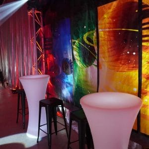 Space themed backdrop, led bar tables and black bar stools at space themed party