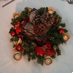 red wreath and pinecones christmas centrepiece
