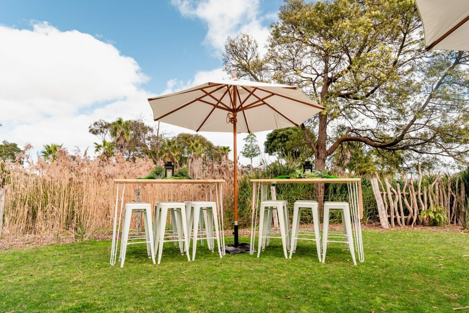 bar tables and stools with umbrellas at werribee zoo events secret garden