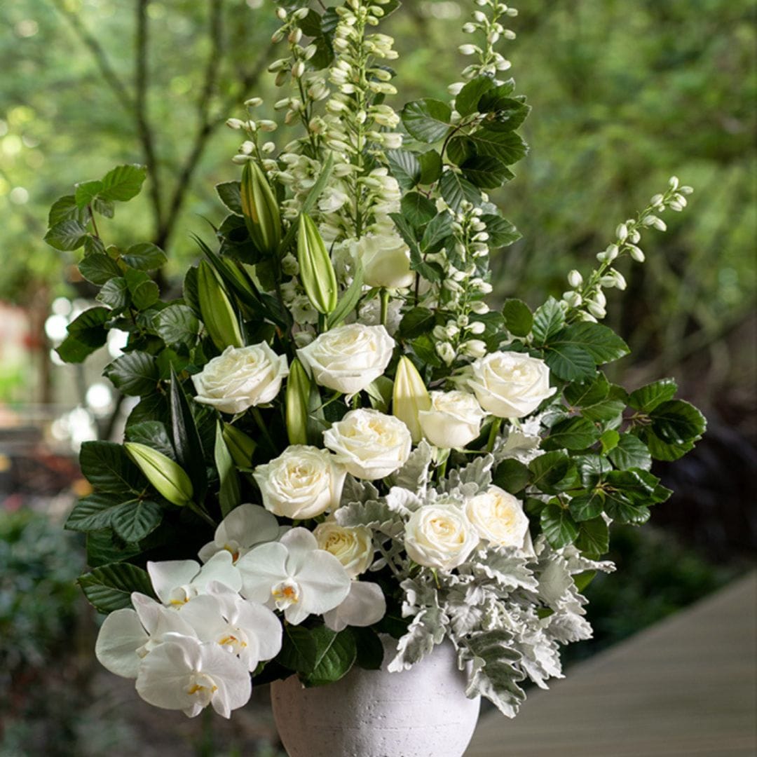 white and greenery floral arrangement by flower temple