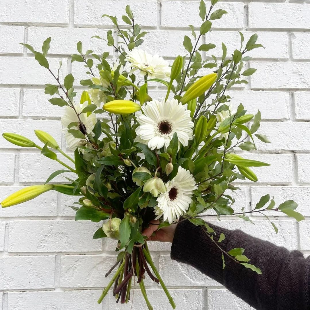 white and green floral arrangement by grown florists