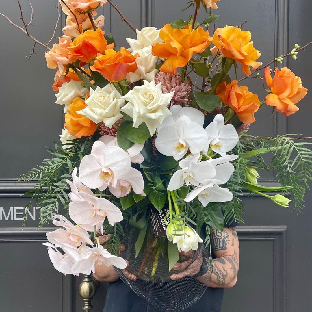 orange and white floral arrangement by victoria whitelaw