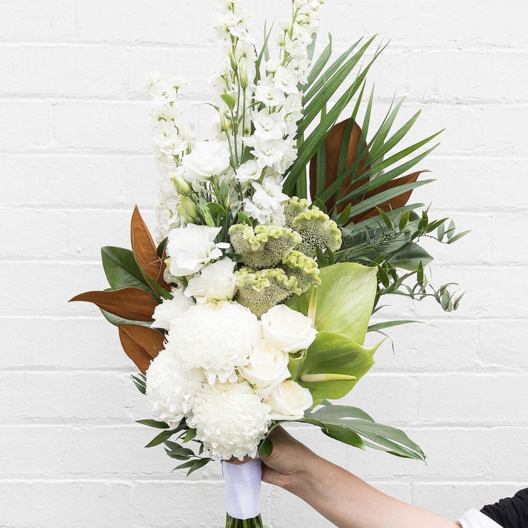 white and green floral arrangement by fig & bloom