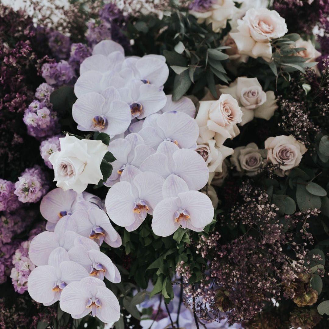lilac and purple floral arrangement by clover flower co