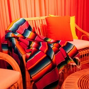 mexican throw on rattan lounge chair