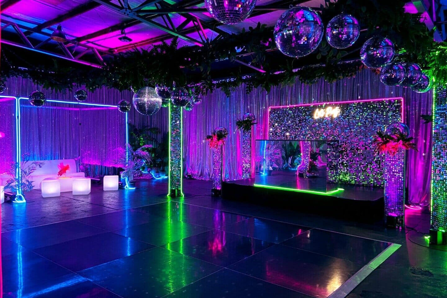 dance floor area with mirror balls and neon lights