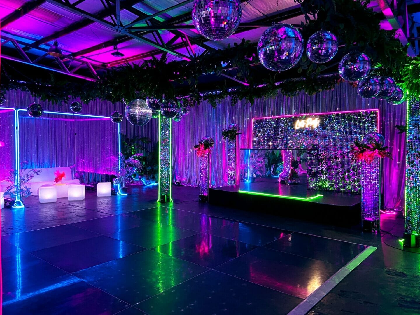 dance floor area with mirror balls and neon lights