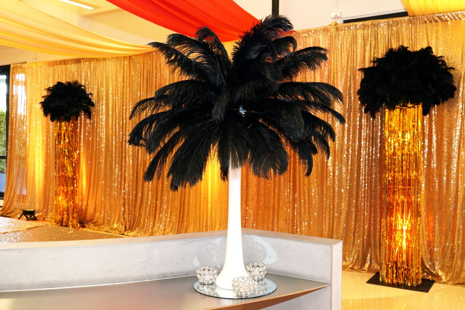 feather centrepiece and gold sequin drape