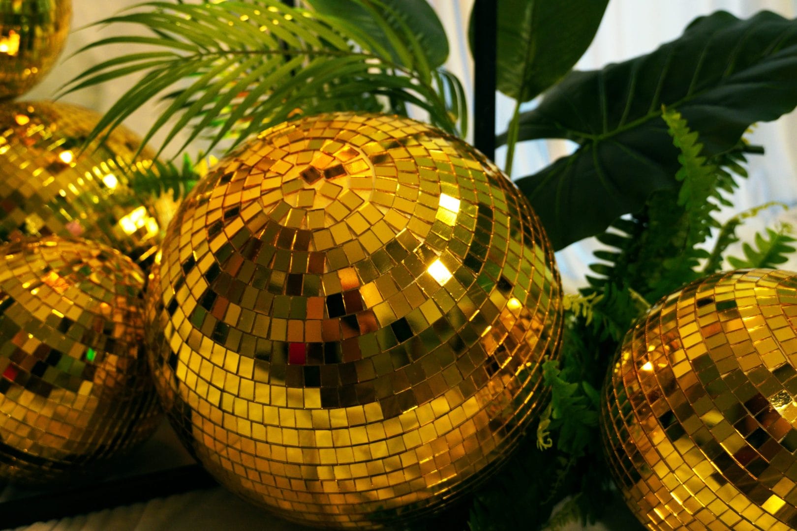 gold mirror ball and greenery