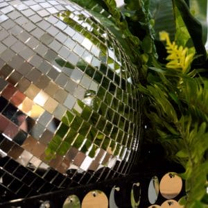 disco centrepiece with silver mirror balls, silver sequin, and greenery