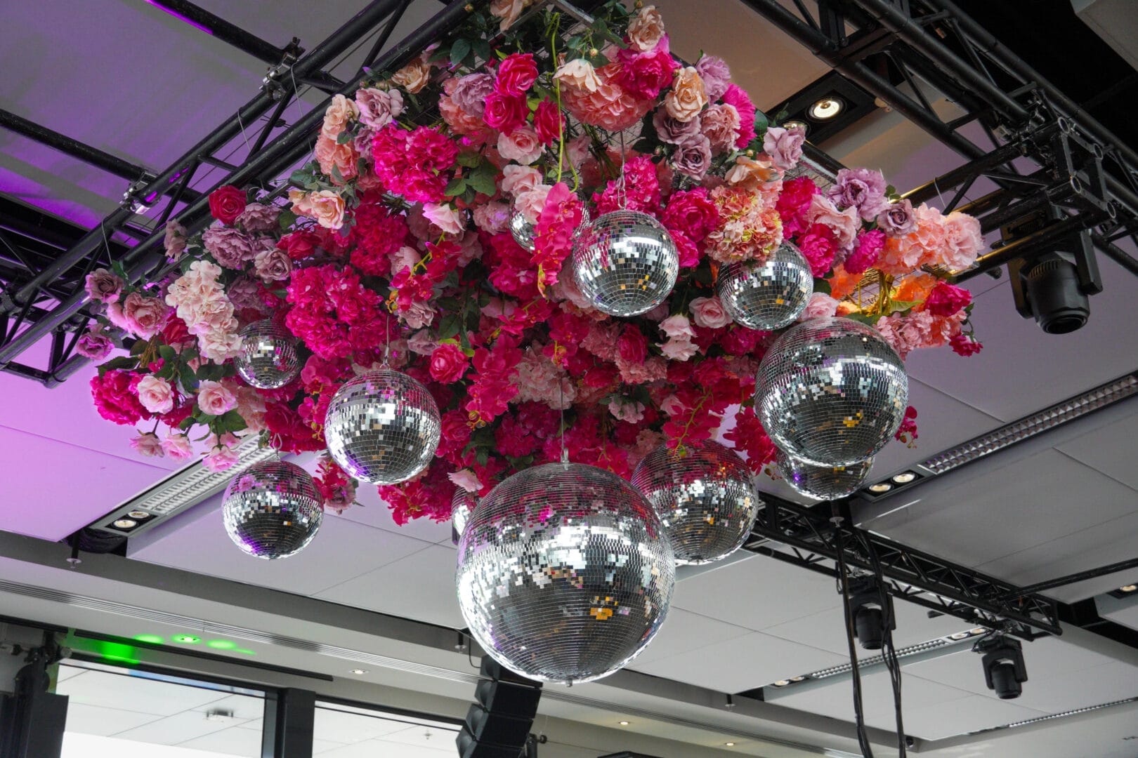 pink floral and silver disco ball ceiling installation