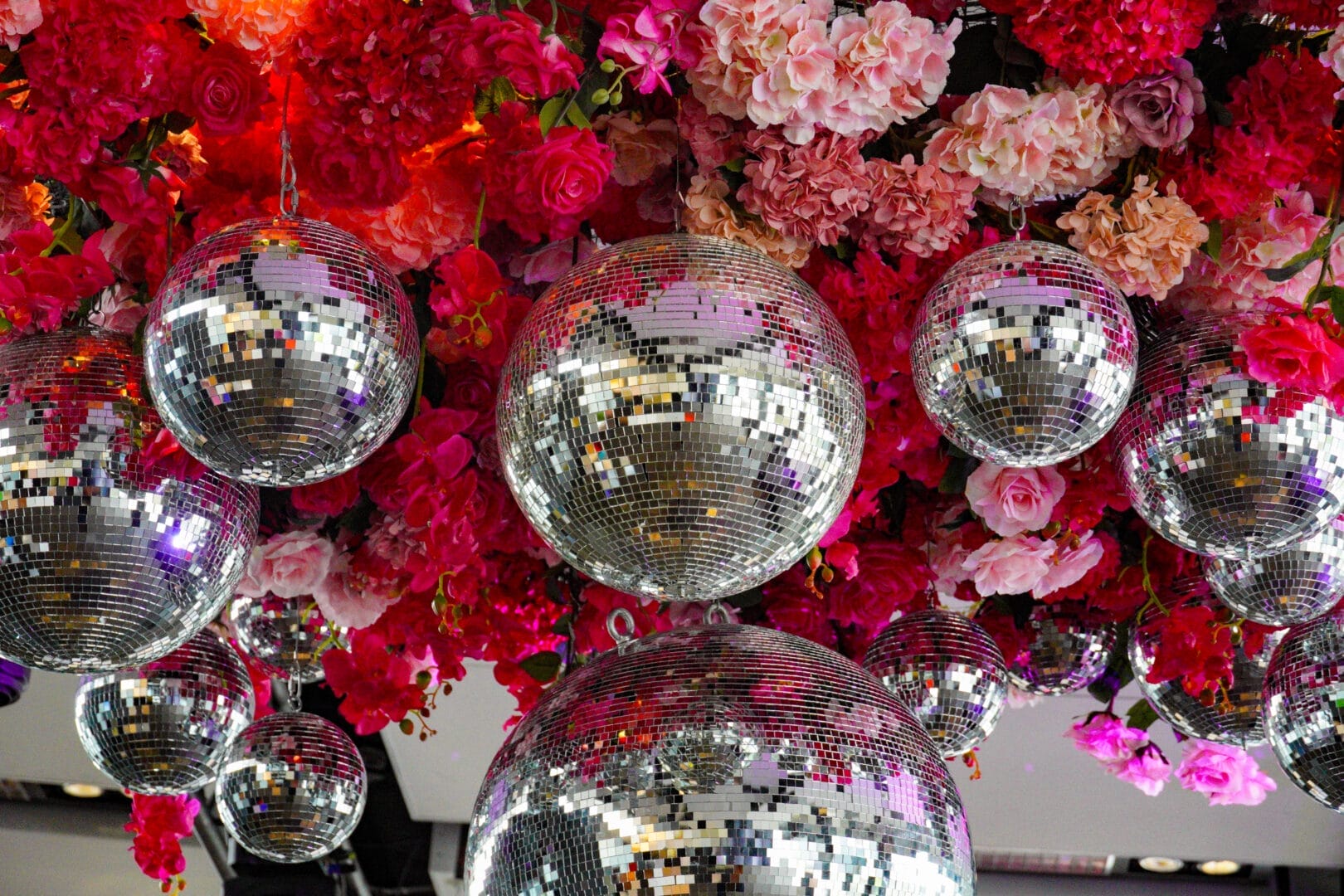 pink florals and silver mirror ball ceiling installation