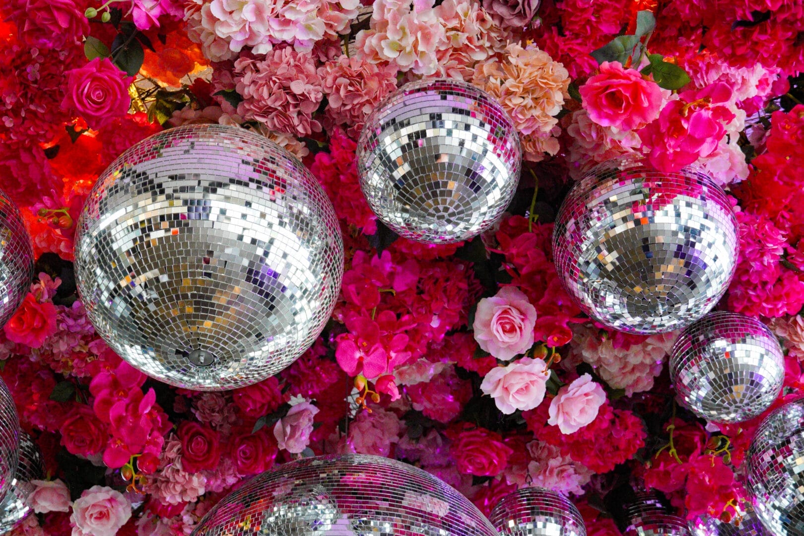 Pink floral and disco ball ceiling installation