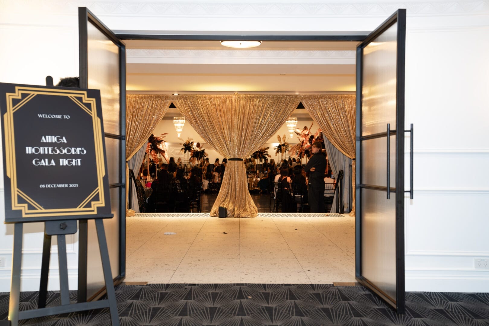 entrance to end of year gala with custom gatsby inspired entrance sign